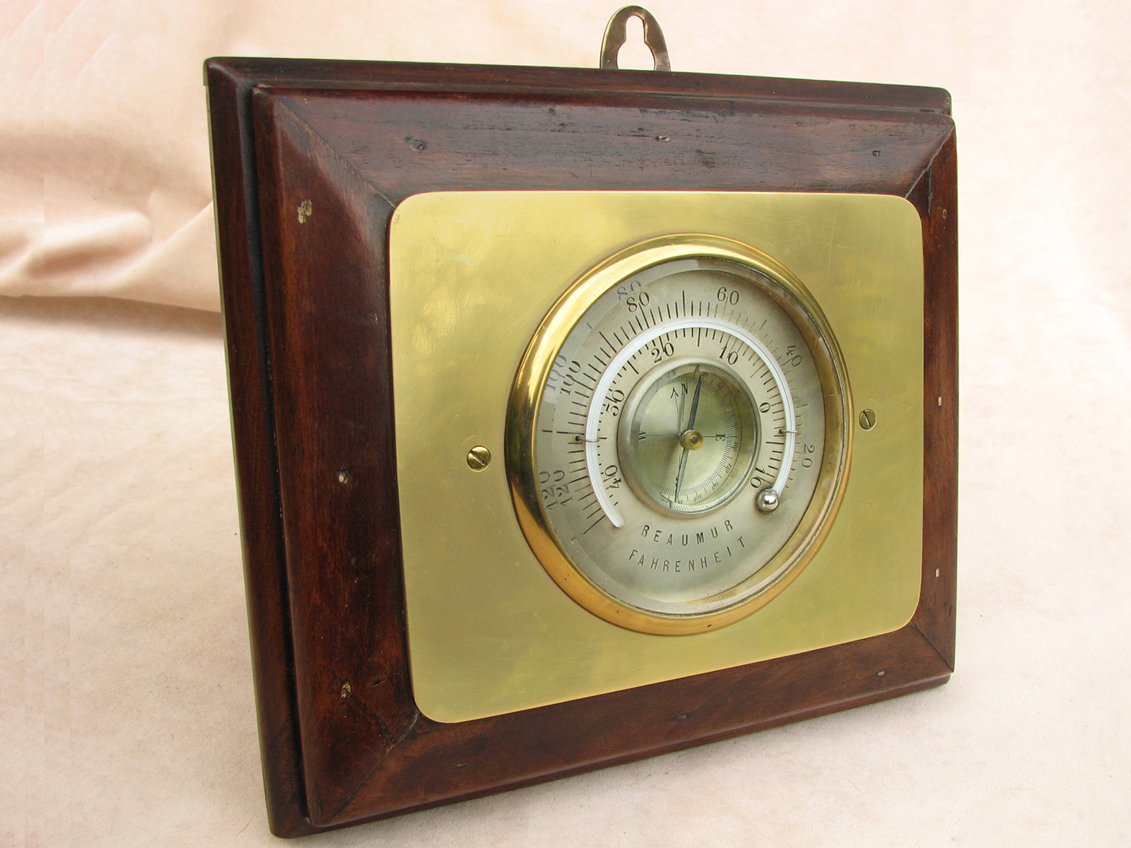 Unusual compass and thermometer combination mounted on wooden backboard